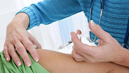 A practitioner administering a vaccine to a patient 